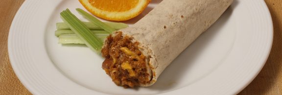 Plate of foodservice Posada Mexican Bean & Cheese Burrito in a school setting